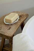 Rustic wooden stool by bath