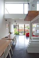 Open plan dining area with stairs and mezzanine