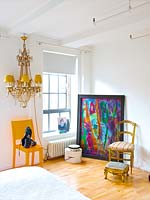 Eclectic furniture and accessories in bedroom corner