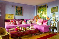 Pink corner sofa with patterned cushions