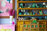 Colourful crockery on dresser