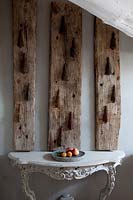 Rustic wooden panels above ornate console table