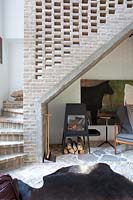 Modern wood burning stove under stairs