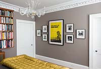 Framed posters and photos on bedroom wall