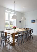 Wooden dining table and painted chairs