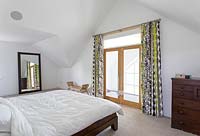 Patterned curtains at bedroom window