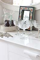 Crystal glasses on white sideboard