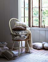 Patterned cushions on wooden chair