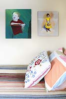 Portrait paintings above bed