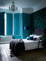 Turquoise shutters at bedroom window