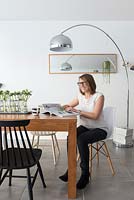 Woman sitting in modern dining room