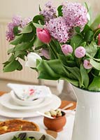 Jug of Tulips and Hyacinth flowers on dining table