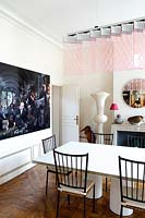 Modern dining room with pink suspended light by Johanna Grawunder