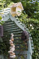 Arbour seat decorated with pebbles and lanterns