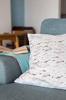 Patterned cushion on blue sofa