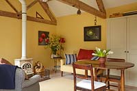 Open plan living and dining areas with exposed beams