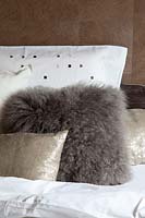 Fluffy cushions on bed