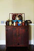 Pottery display on wooden cabinet