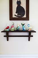 Bird ornaments on wooden shelf