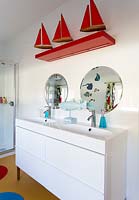 Bathroom sinks with colourful toys and ornaments