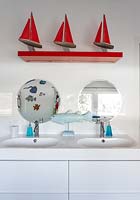 Bathroom sinks with colourful toys and ornaments
