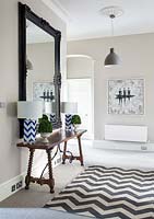 Patterned lamps on console table