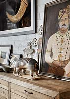 Eclectic ornaments and art on wooden chest