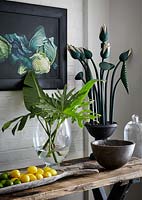 Tropical foliage arrangement in glass vase