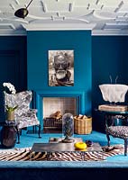 Eclectic furniture and accessories around fireplace