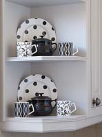 Patterned crockery on kitchen shelves