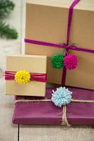 Christmas presents decorated with wool pompoms