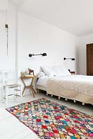Patterned rug by bed