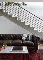 Leather sofa beside stairs