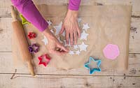Making clay stars - Use a wooden skewer to create small holes on the tip of each star