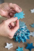 Making a felt christmas tree - Add the felt stars to the thin wire in size order from large to small