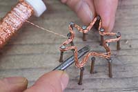 Making copper wire star decorations - Use a screwdriver or similar object to help remove the star from the nails