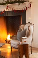 Armchair by fireplace