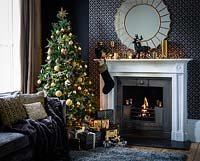 Christmas tree by fireplace