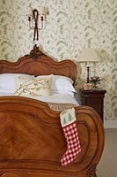 Ornate bed with christmas stocking