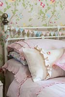Pink cushions on bed
