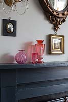 Colourful glassware on mantlepiece