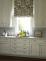 Patterned roman blinds in kitchen