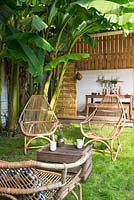 Cane armchairs on lawn