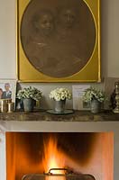 Pots of white Roses on mantlepiece