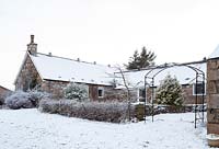 House and garden under snow