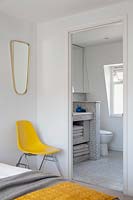 Yellow chair in bedroom corner