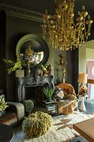 Eclectic furniture and accessories around fireplace
