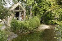 Converted outbuilding beside pond