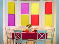 Colourful window treatment in dining area