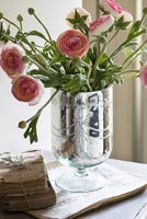 Ranunculus flowers in silver vase